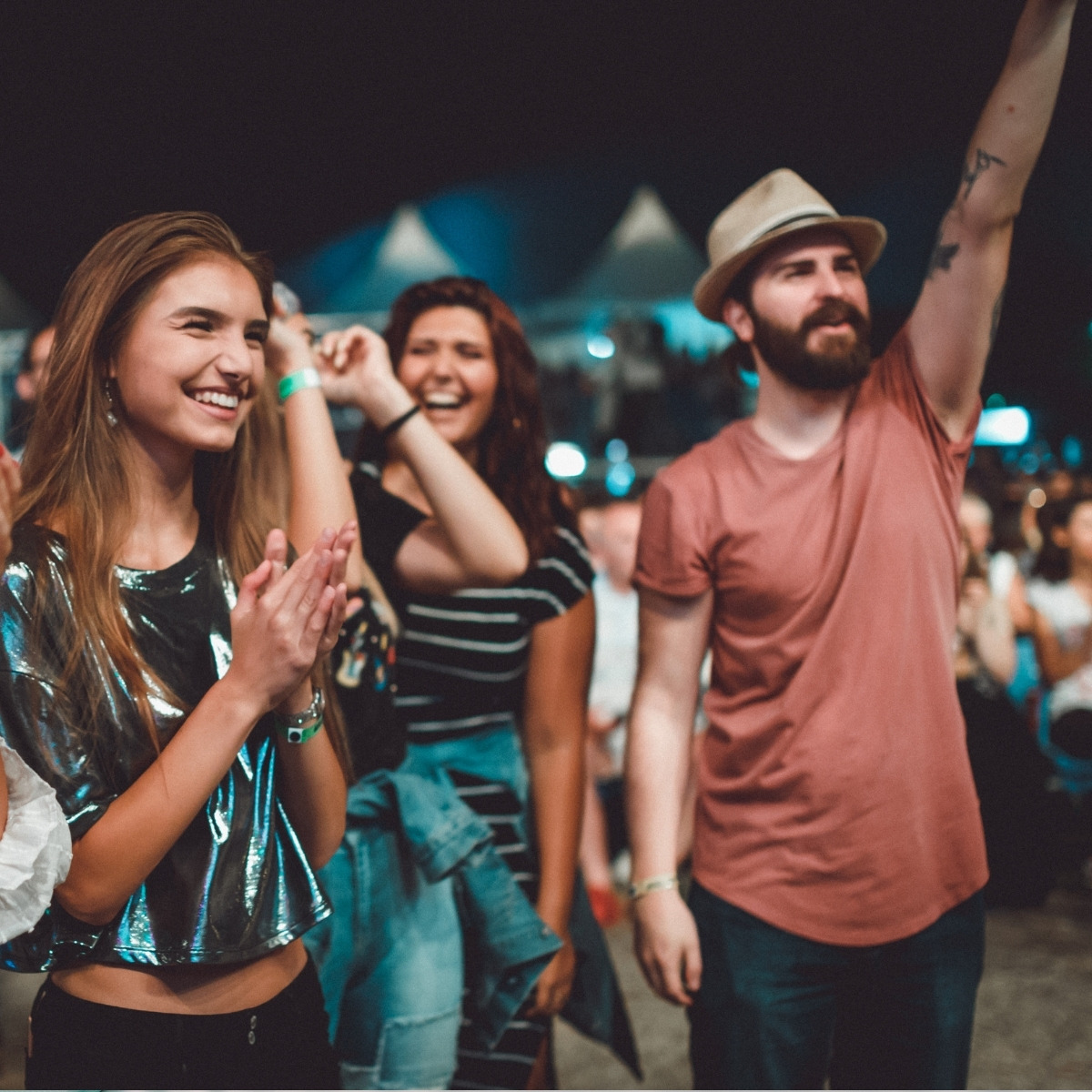 qrun-event-transport-featured-2026 Group of friends walking towards a Bristol venue at night for pre-booked event transport