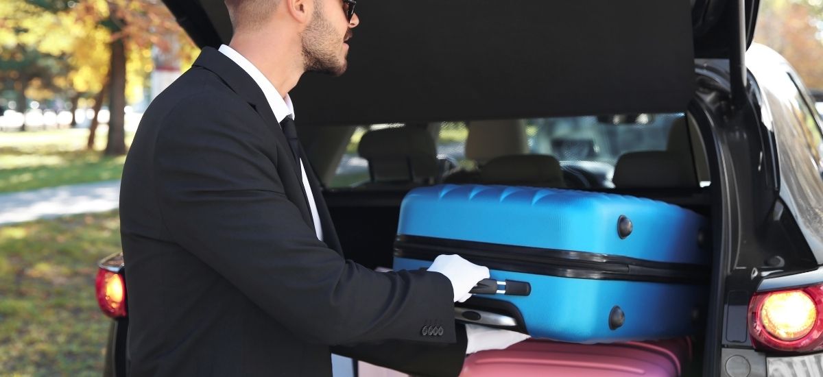 qrun-long-distance-luggage-loading Driver loading suitcases into a long distance taxi from Bristol for a nationwide journey